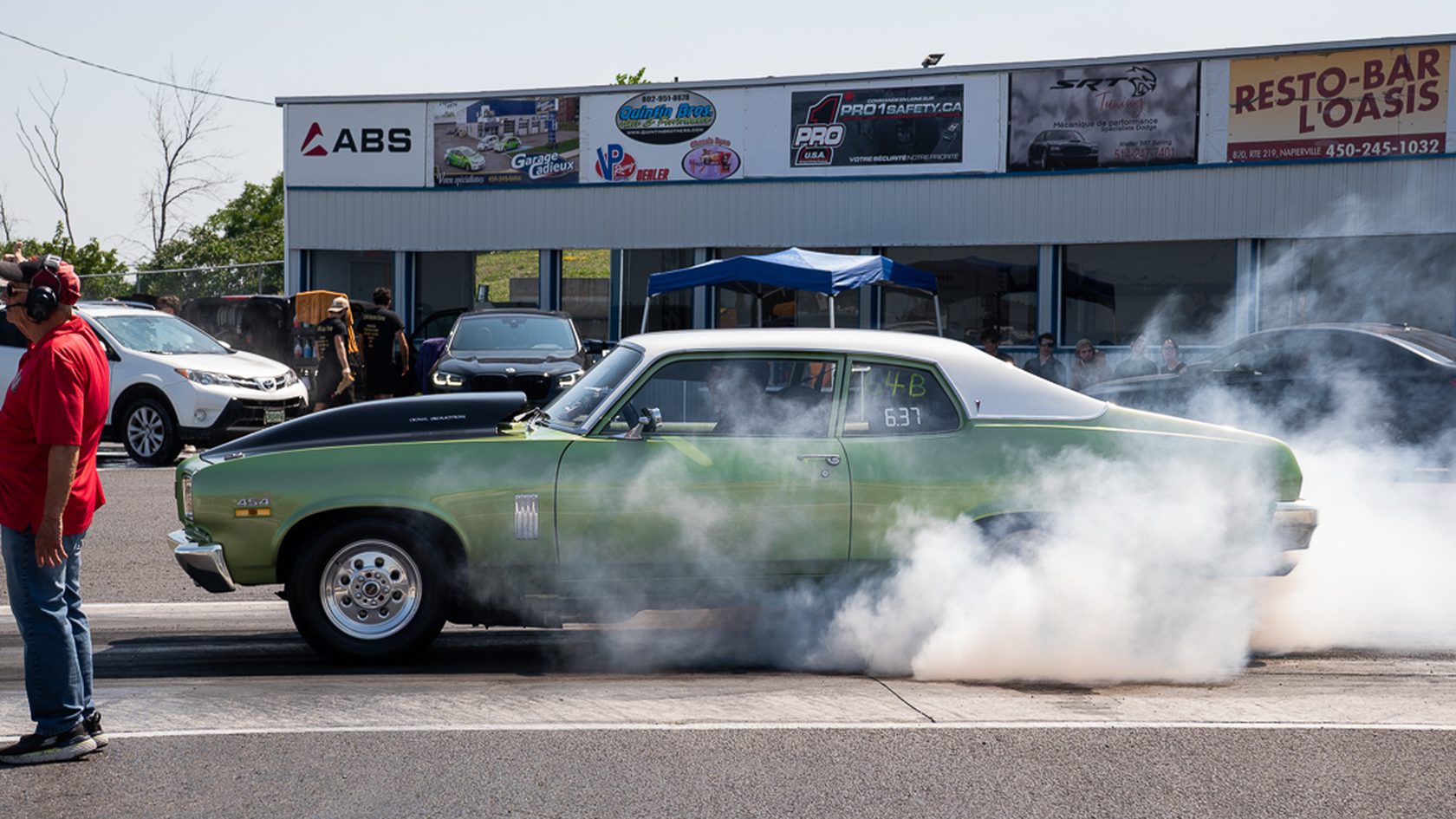 A muscle car burnout in front of the crowd